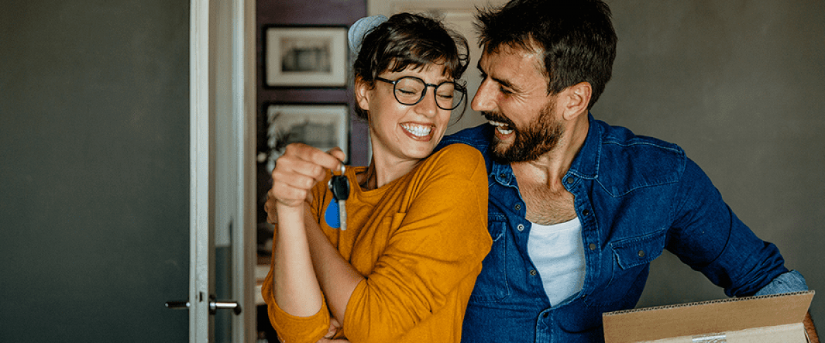 A couple is happily dancing in their kitchen