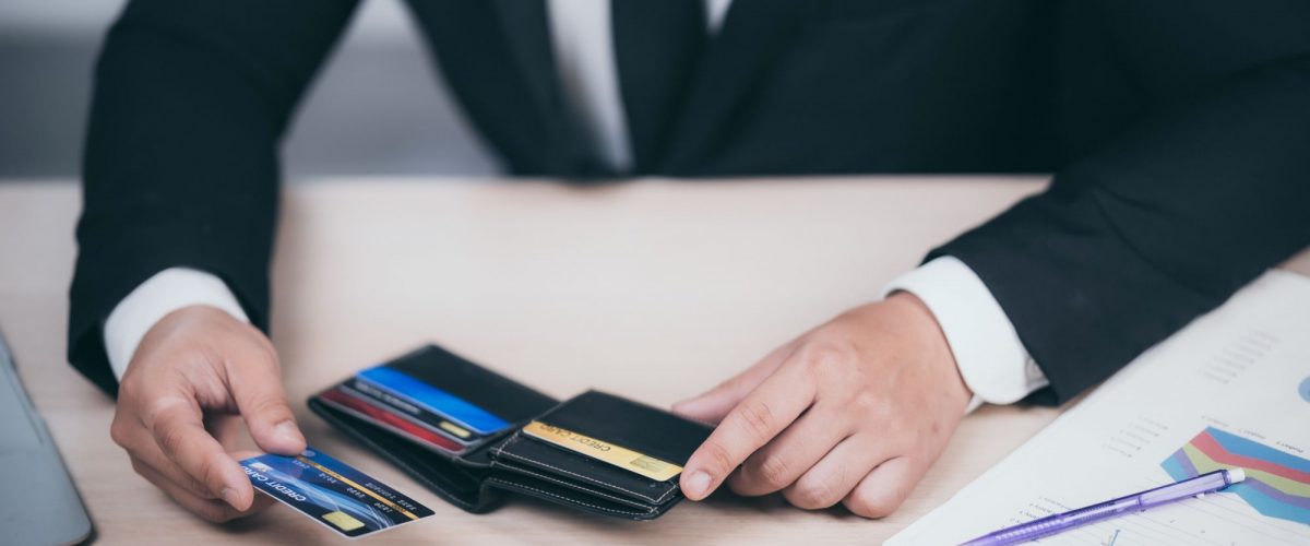Business man holding a credit card